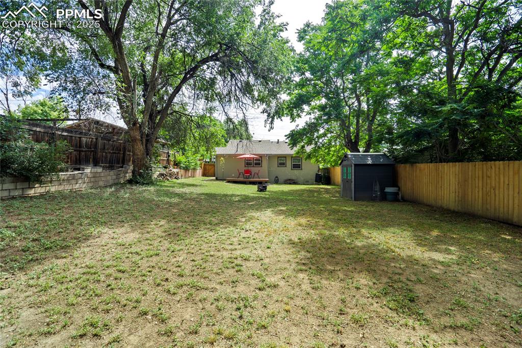 Image 27 of 28: Fenced backyard featuring a shed