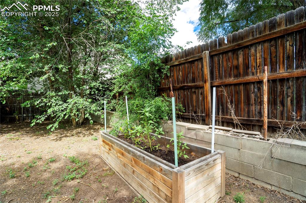 Image 28 of 28: View of yard featuring a vegetable garden