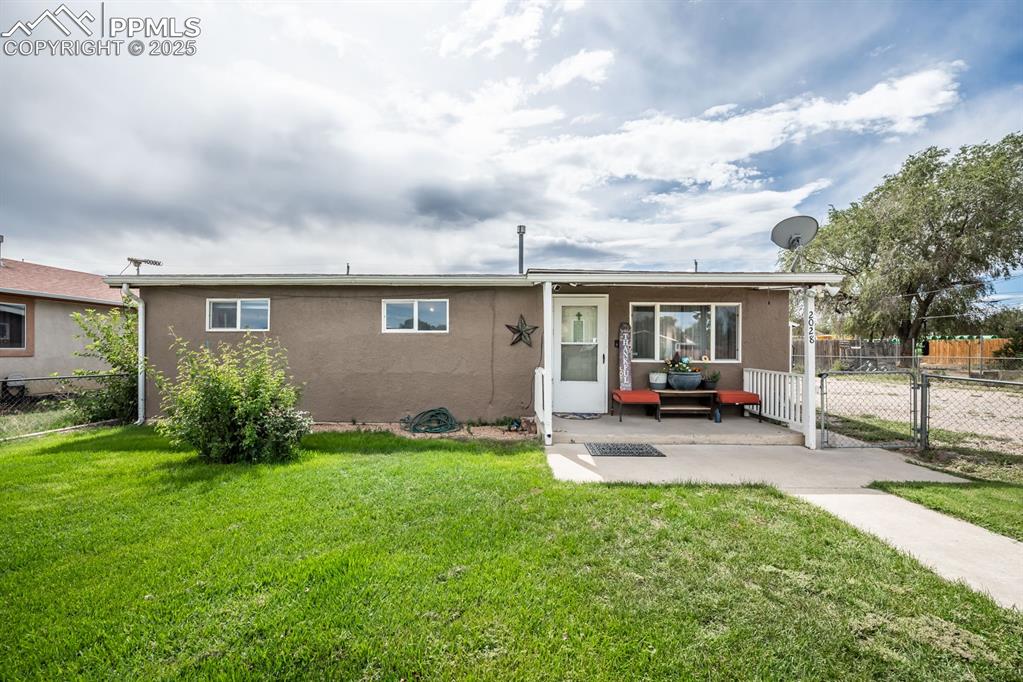 Image 1 of 24: View of front of home with stucco siding, a patio, and a gate