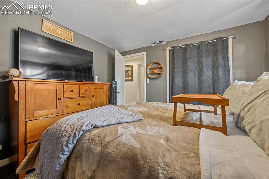 Image 11 of 24: Bedroom with a textured ceiling