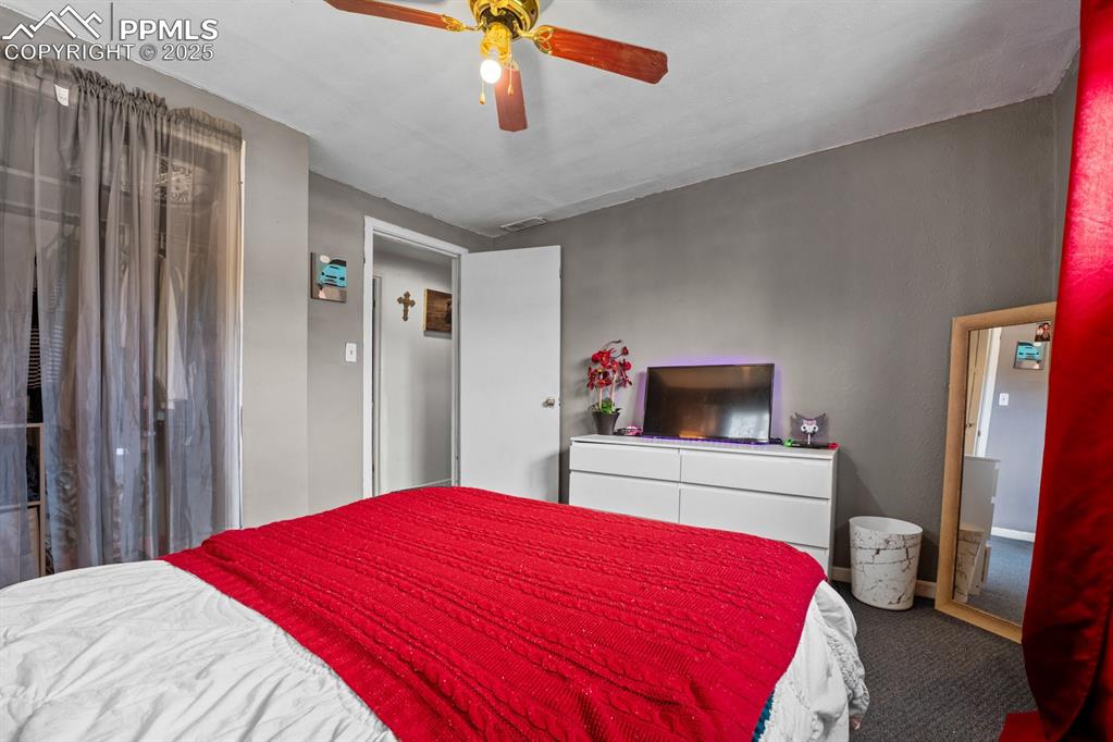 Image 13 of 24: Bedroom featuring a ceiling fan and carpet