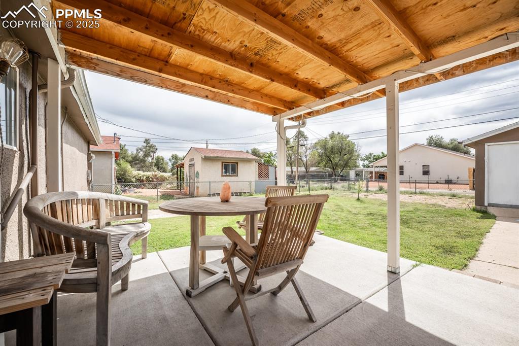 Image 18 of 24: View of patio with outdoor dining area