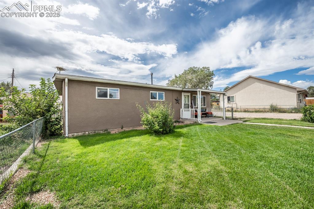 Image 2 of 24: View of front of home featuring stucco siding, a fenced backyard, and a pat