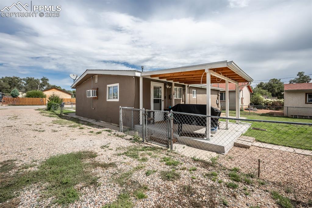 Image 21 of 24: Rear view of property with a deck and stucco siding