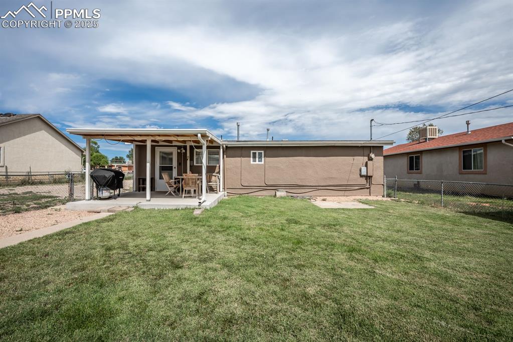 Image 23 of 24: Rear view of property featuring a fenced backyard, a patio area, stucco sid
