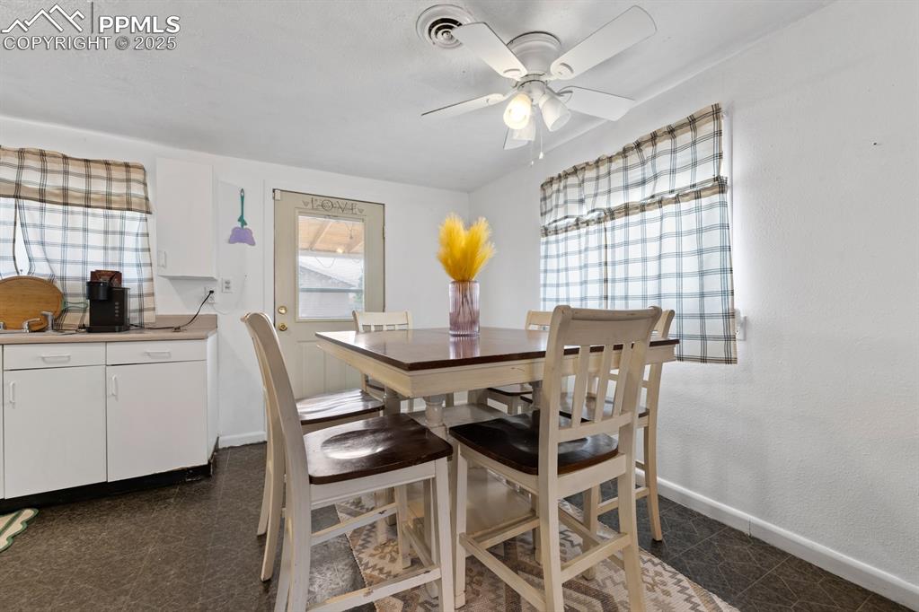 Image 6 of 24: Dining space featuring granite floors and ceiling fan