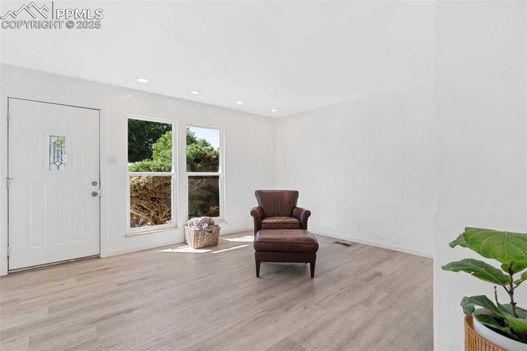 Image 3 of 15: Entry and living room have wood laminate floors
