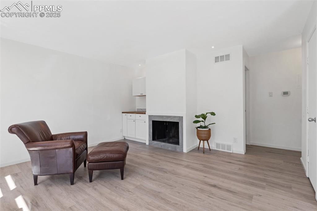 Image 4 of 15: Wood burning fireplace and built-ins in living room