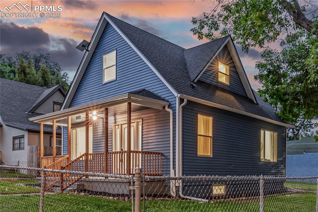 Image 2 of 39: View of front of property with a fenced front yard, roof with shingles, and