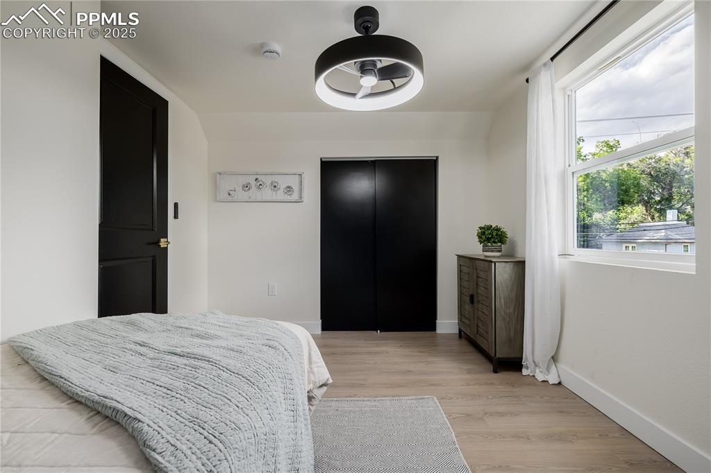 Image 26 of 39: Bedroom with light wood-type flooring and a ceiling fan