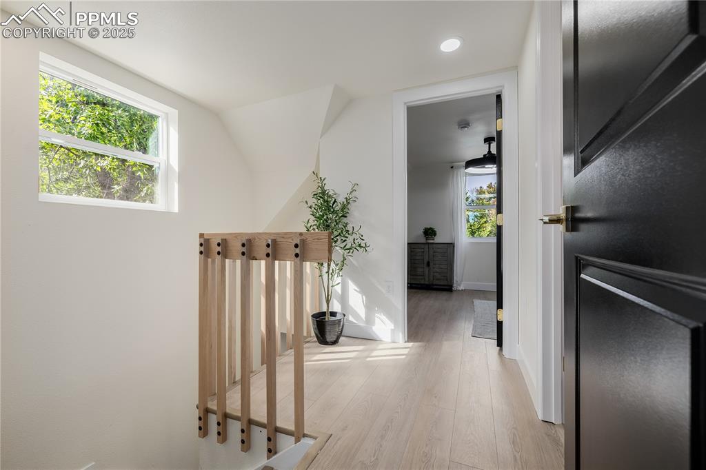 Image 27 of 39: Hall featuring light wood-style flooring and recessed lighting