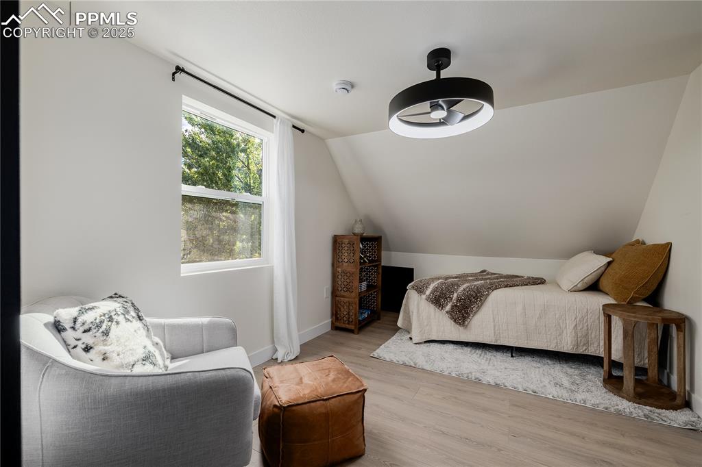Image 30 of 39: Bedroom with wood finished floors, lofted ceiling, and ceiling fan