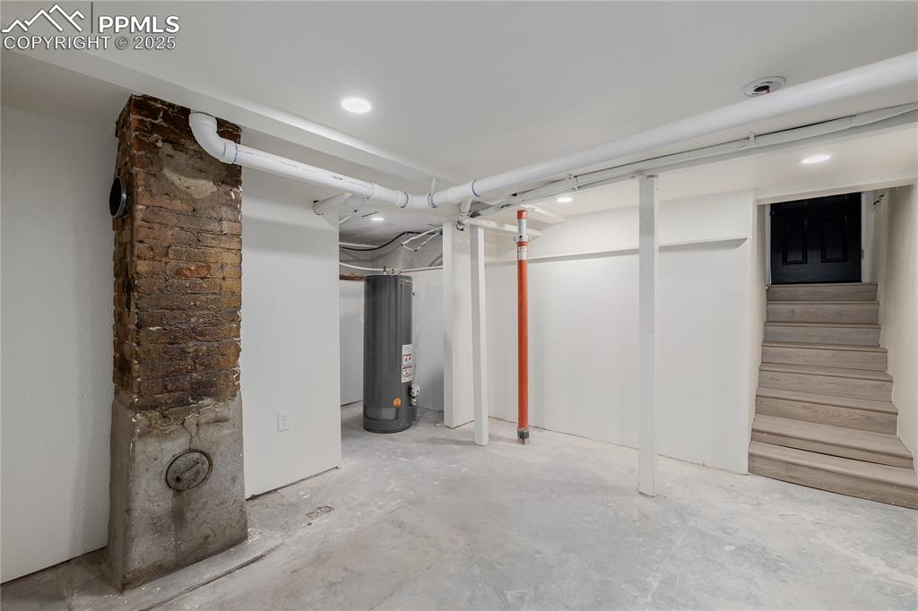 Image 31 of 39: Finished below grade area with gas water heater