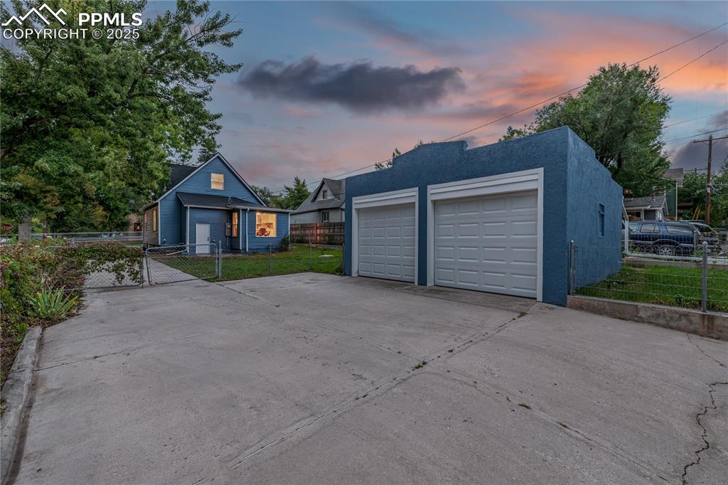 Image 35 of 39: Detached garage with a gate