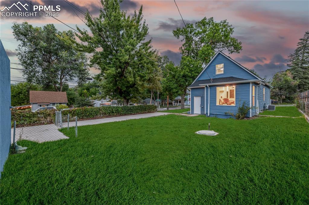 Image 38 of 39: View of yard at dusk