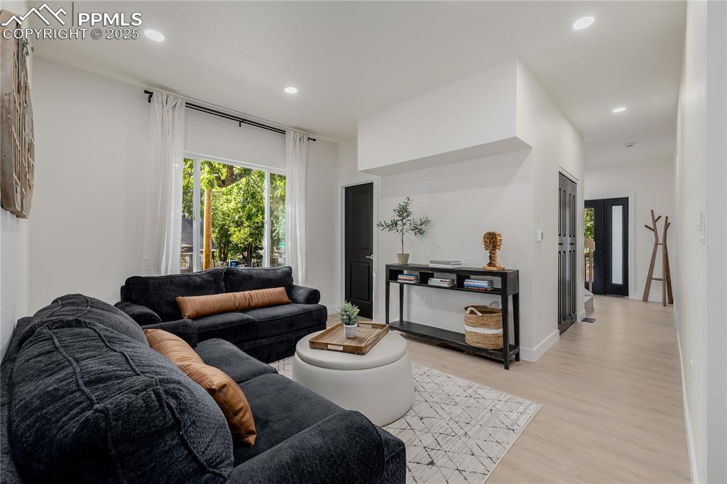 Image 5 of 39: Living area featuring recessed lighting and light wood-style flooring