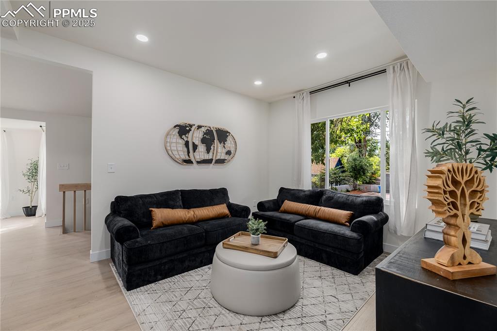 Image 6 of 39: Living room featuring light wood-style flooring and recessed lighting