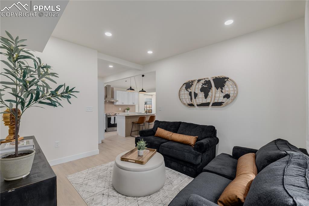 Image 7 of 39: Living area with recessed lighting and light wood-type flooring