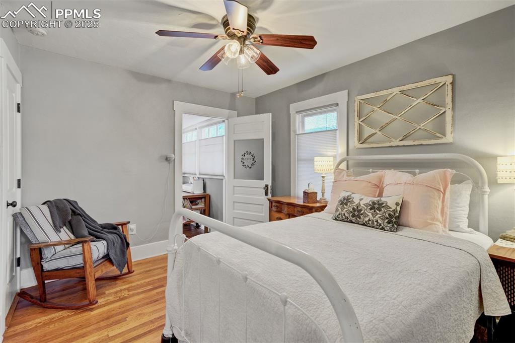 Image 19 of 49: Bedroom featuring light wood finished floors and a ceiling fan