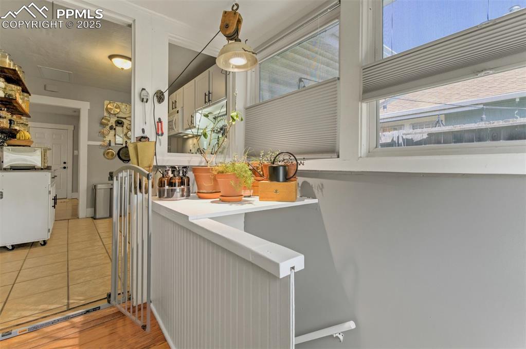 Image 28 of 49: Kitchen with light countertops and light tile patterned floors