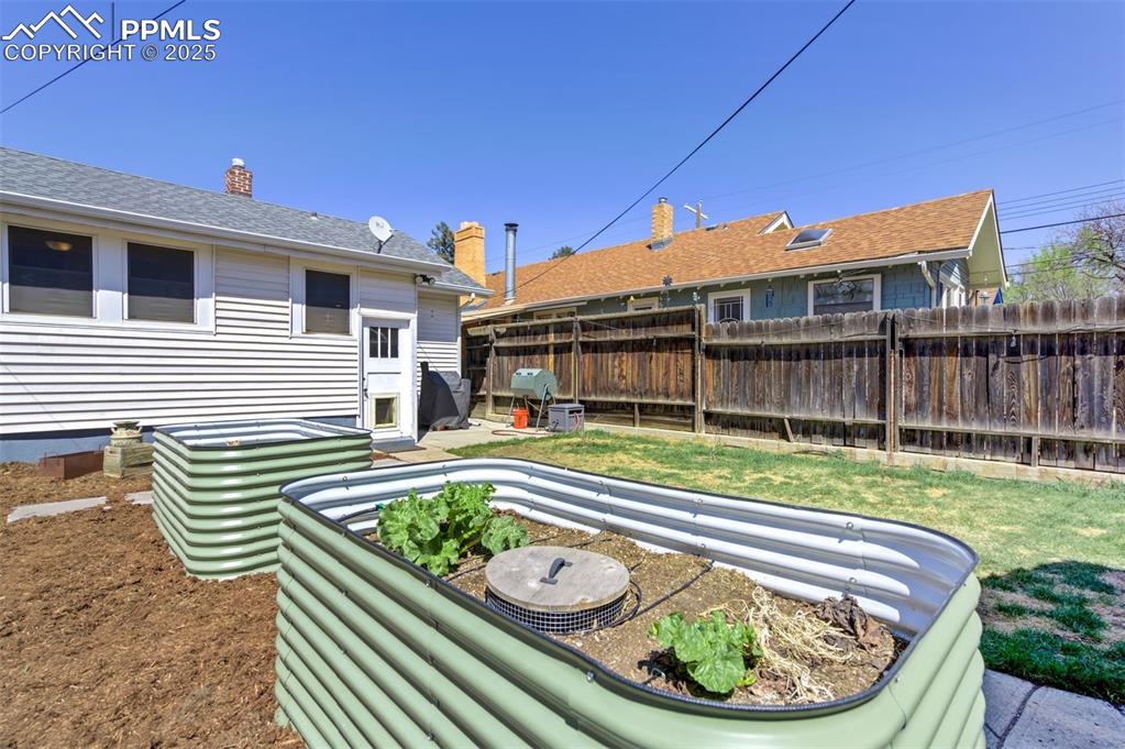 Image 38 of 49: Fenced yard featuring a patio area