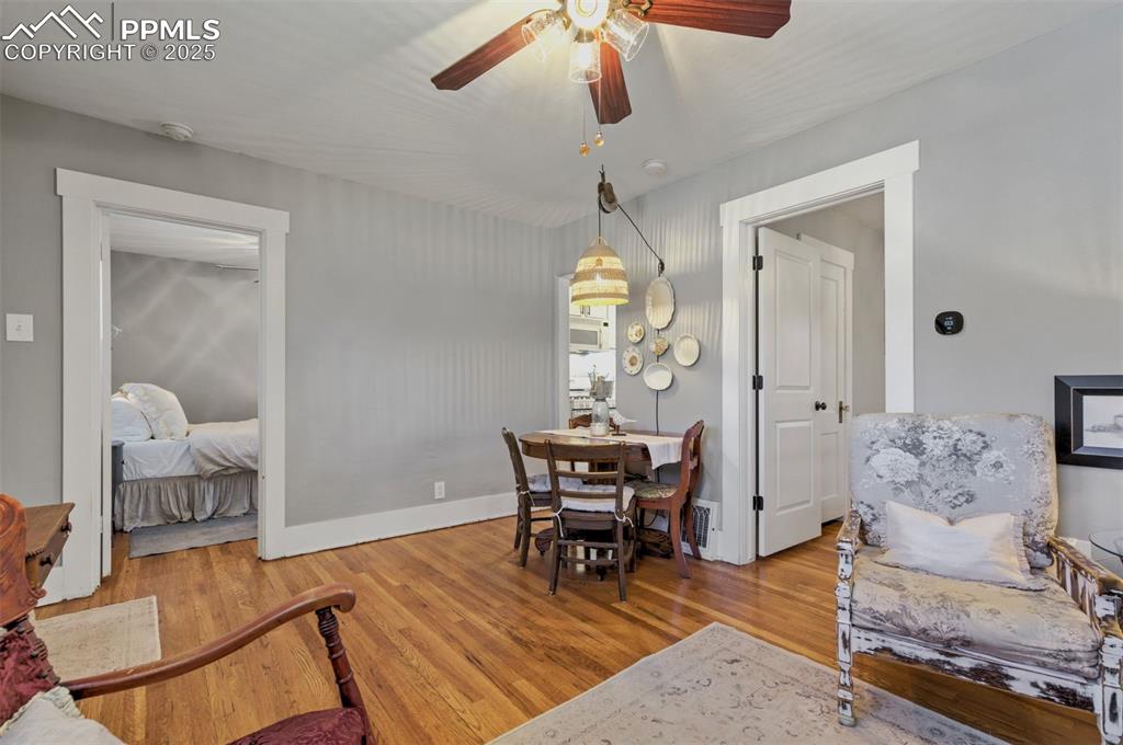 Image 8 of 49: Dining room with light wood-type flooring and ceiling fan