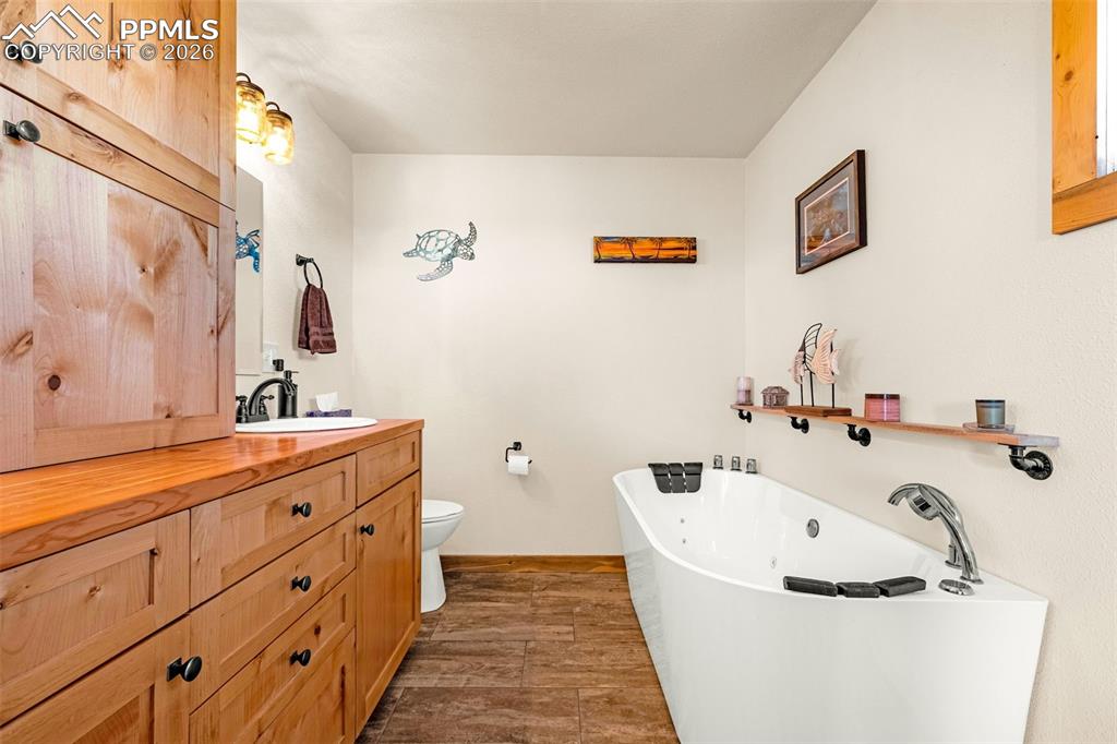 Image 14 of 49: Primary bathroom with jetted tub and double vanity