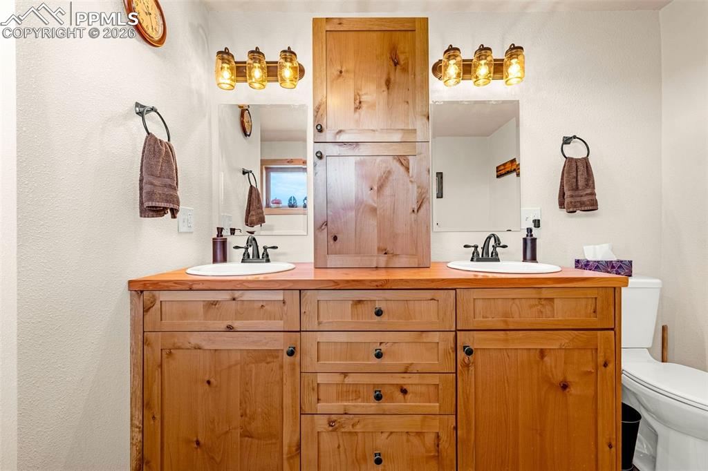 Image 16 of 49: Bathroom featuring double vanity and toilet