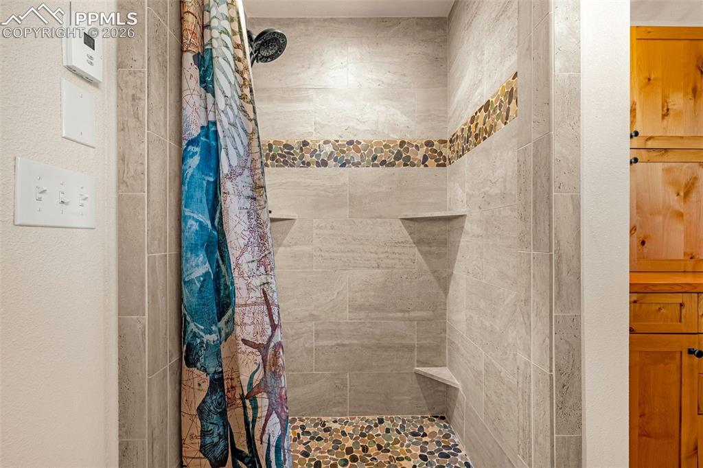 Image 17 of 50: Bathroom featuring a shower stall