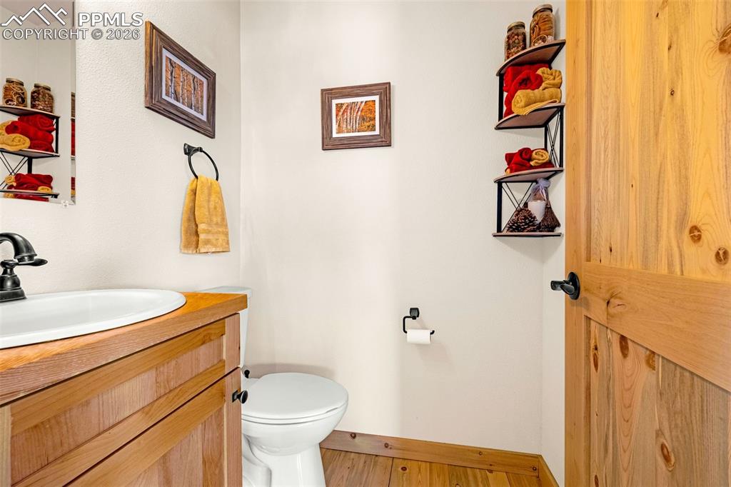 Image 18 of 49: Half bath located in the main living open space for guests
