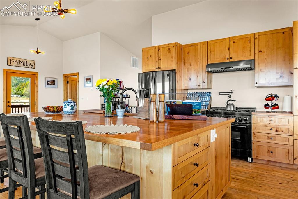 Image 2 of 50: Kitchen with commercial grade gas stove