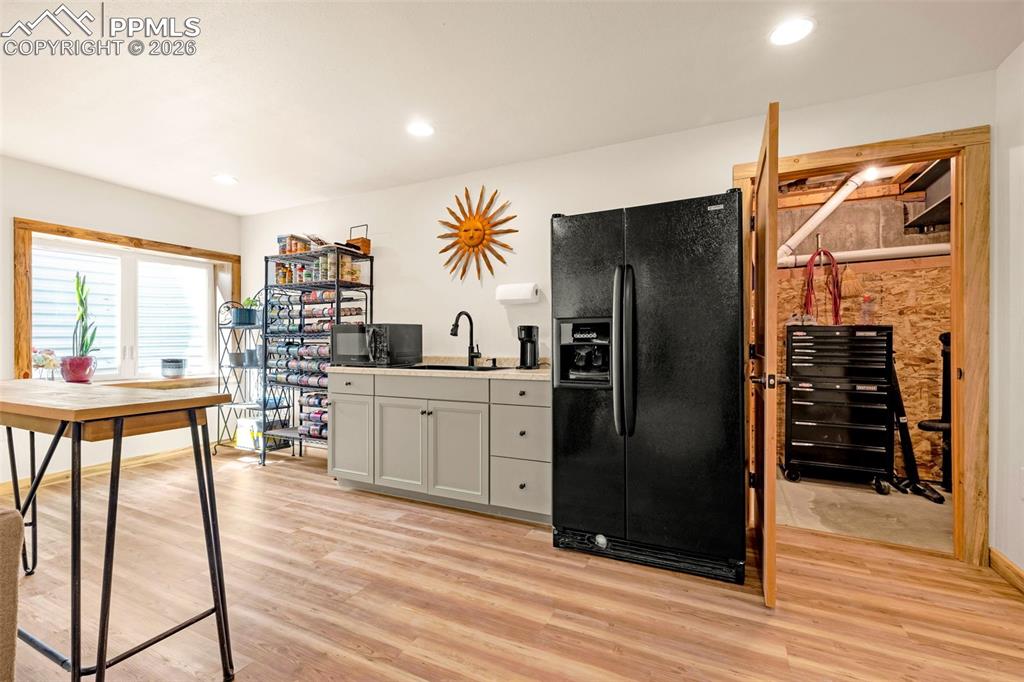Image 25 of 49: Basement Kitchen with fridge, a gas line is installed for future use