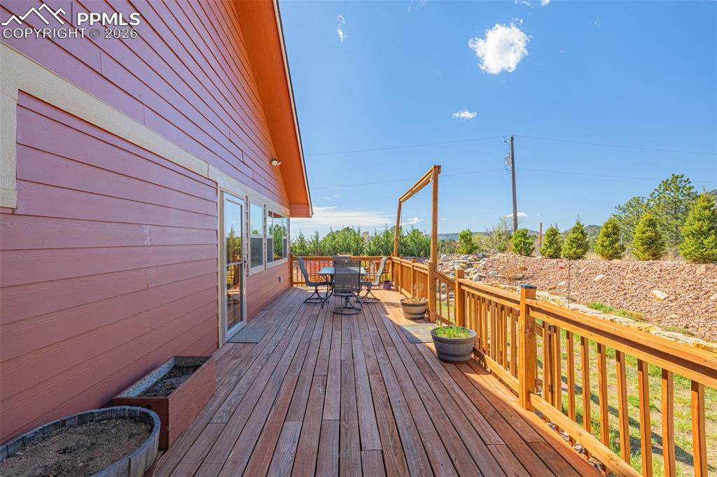 Image 29 of 49: Wooden terrace featuring outdoor dining space