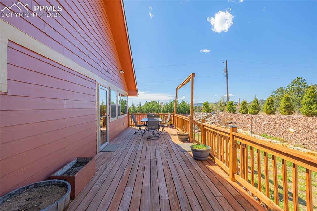 Image 29 of 50: Wooden terrace featuring outdoor dining space