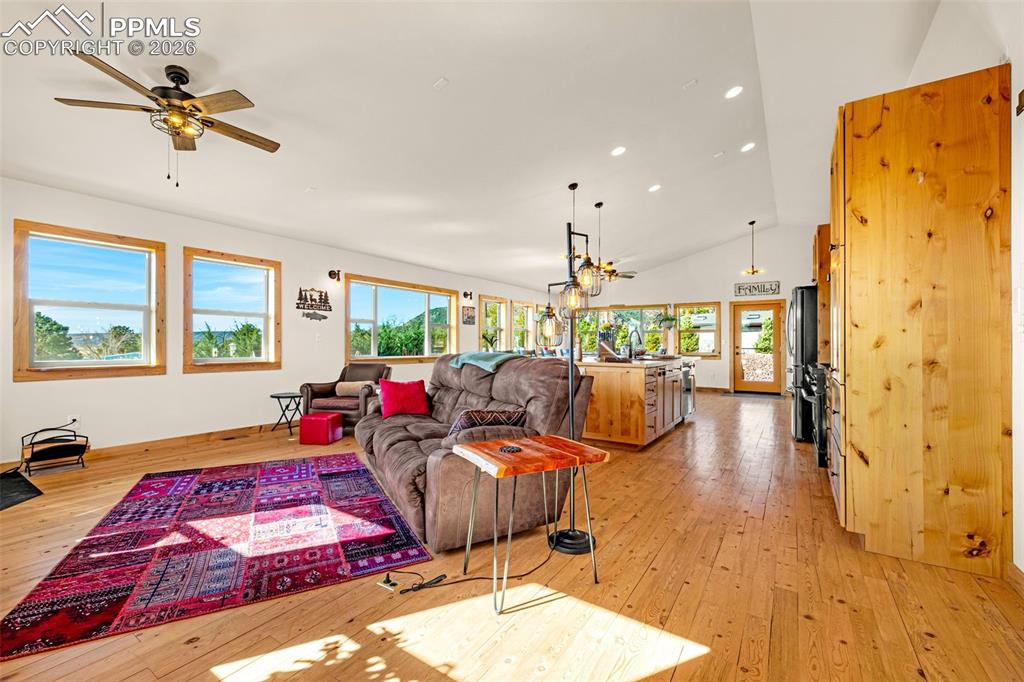 Image 3 of 49: Living area with 13ft vaulted ceiling