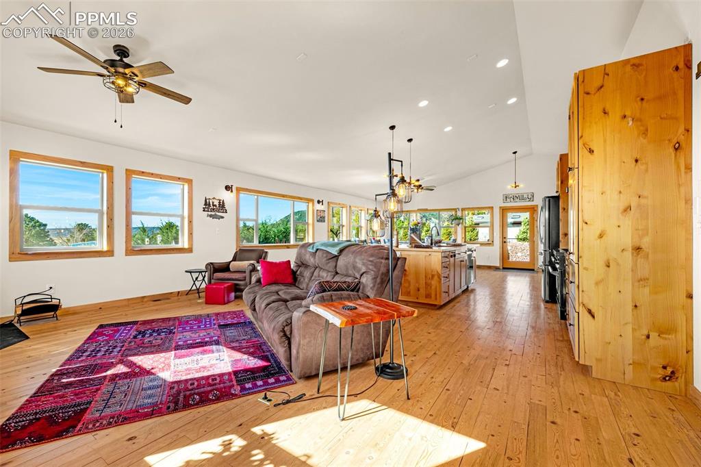 Image 3 of 50: Living area with 13ft vaulted ceiling