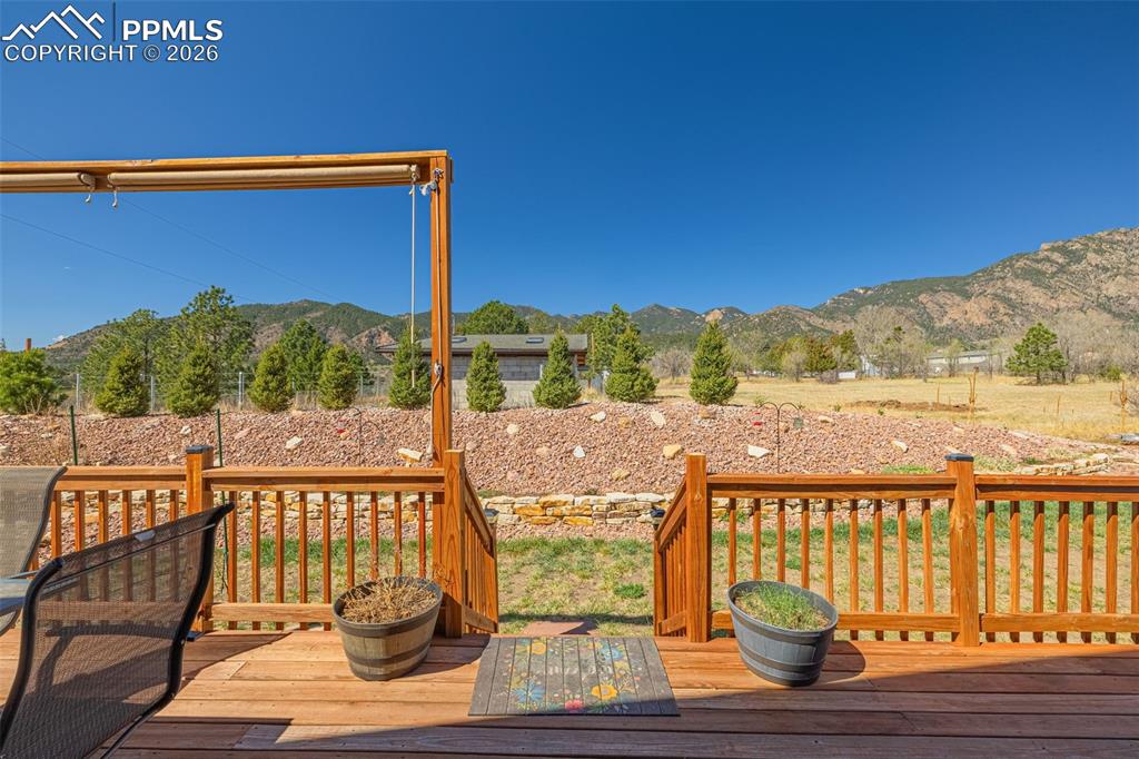 Image 31 of 49: Wooden deck featuring a mountain view