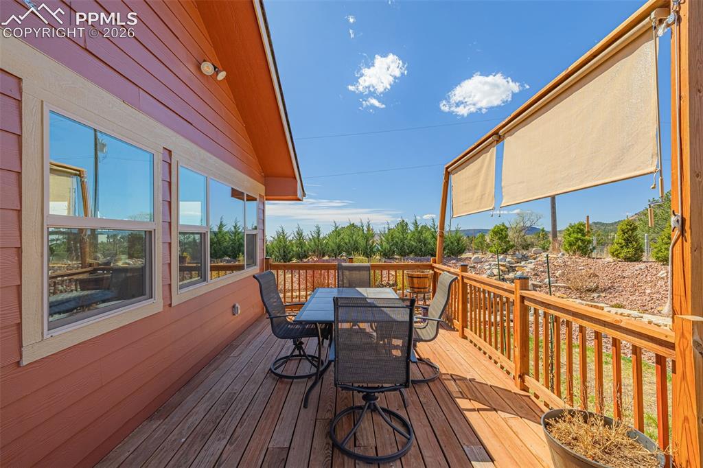 Image 32 of 50: Wooden terrace with outdoor dining space