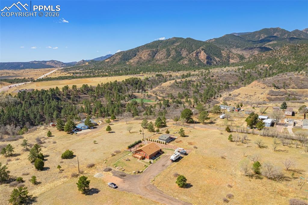 Image 36 of 49: Overview of rural landscape featuring a mountain backdrop