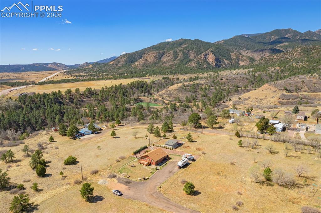 Image 36 of 50: Overview of rural landscape featuring a mountain backdrop