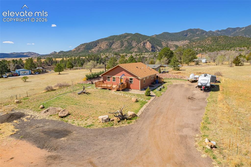Image 39 of 50: View of rural area featuring a mountainous background
