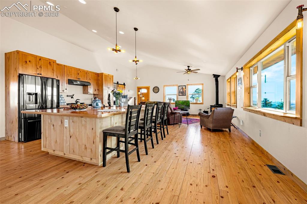 Image 4 of 50: View of kitchen and living room in an open concept living