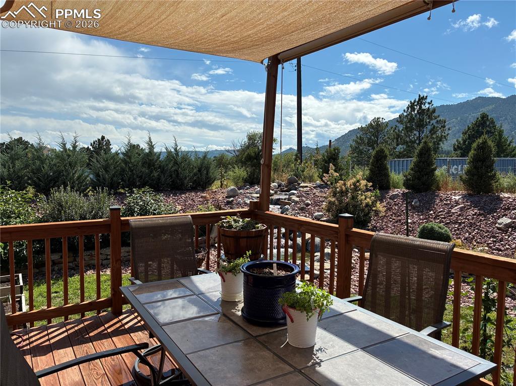 Image 47 of 49: Summer 2025- Wooden deck featuring outdoor dining space and a mountain view