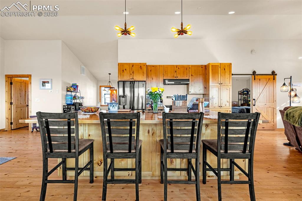 Image 7 of 49: Kitchen with large island and breakfast bar