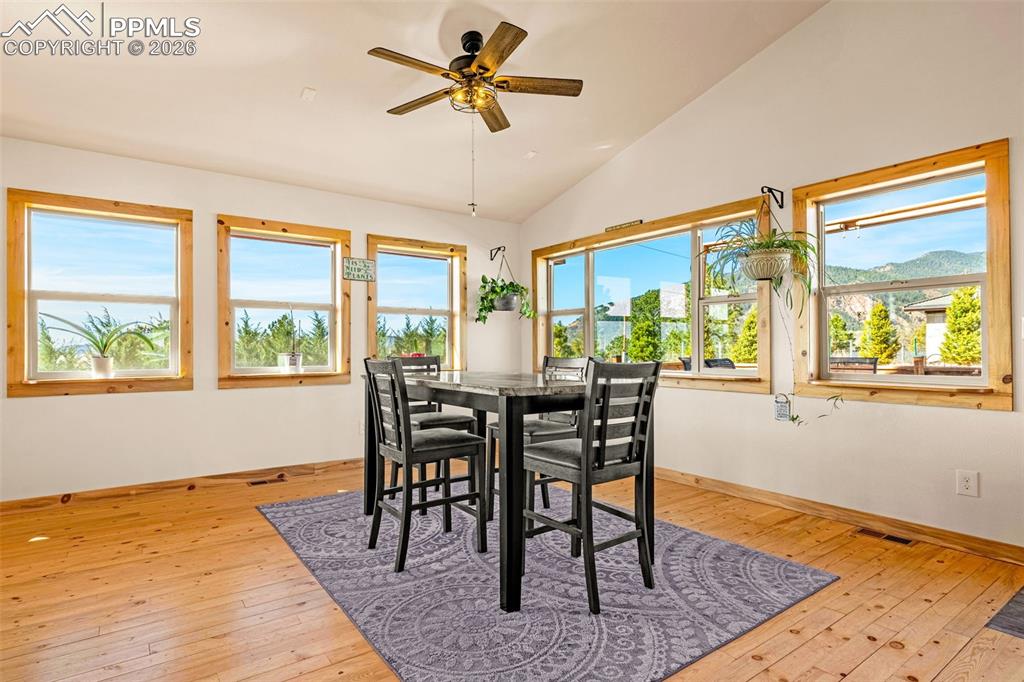 Image 9 of 49: Dining area with lots of windows and natural light with walk-out to back pa