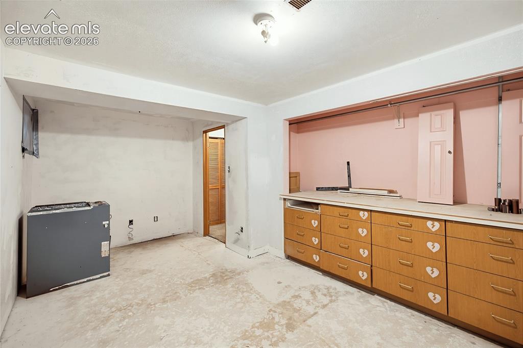 Image 18 of 45: Wood-finish cabinetry with multiple drawers and a continuous countertop