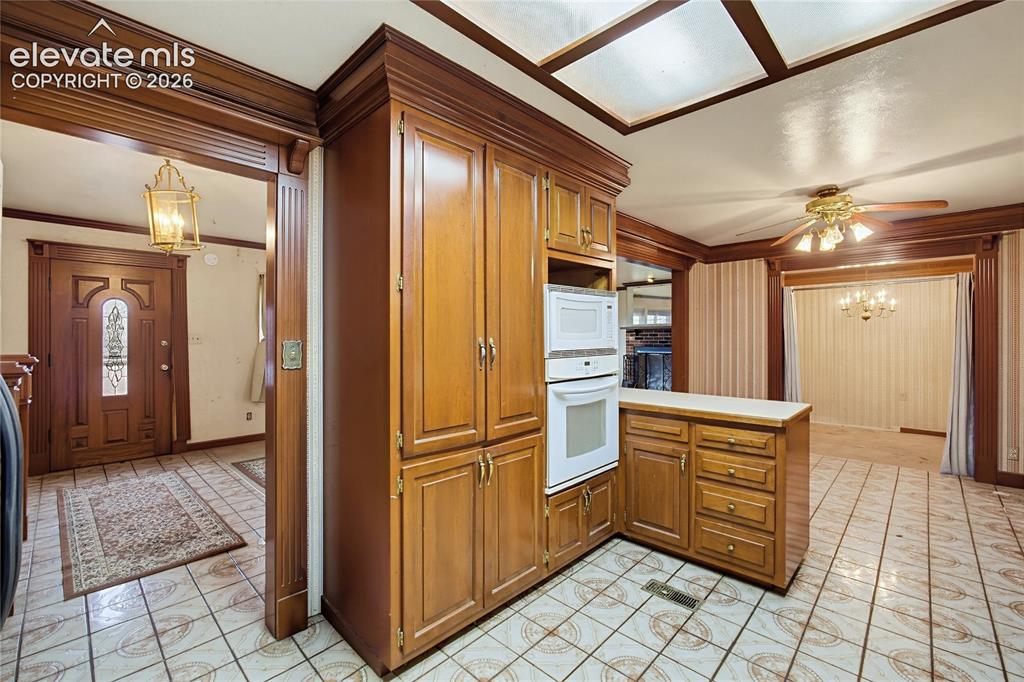 Image 29 of 45: Built-in wood cabinetry with integrated microwave and oven