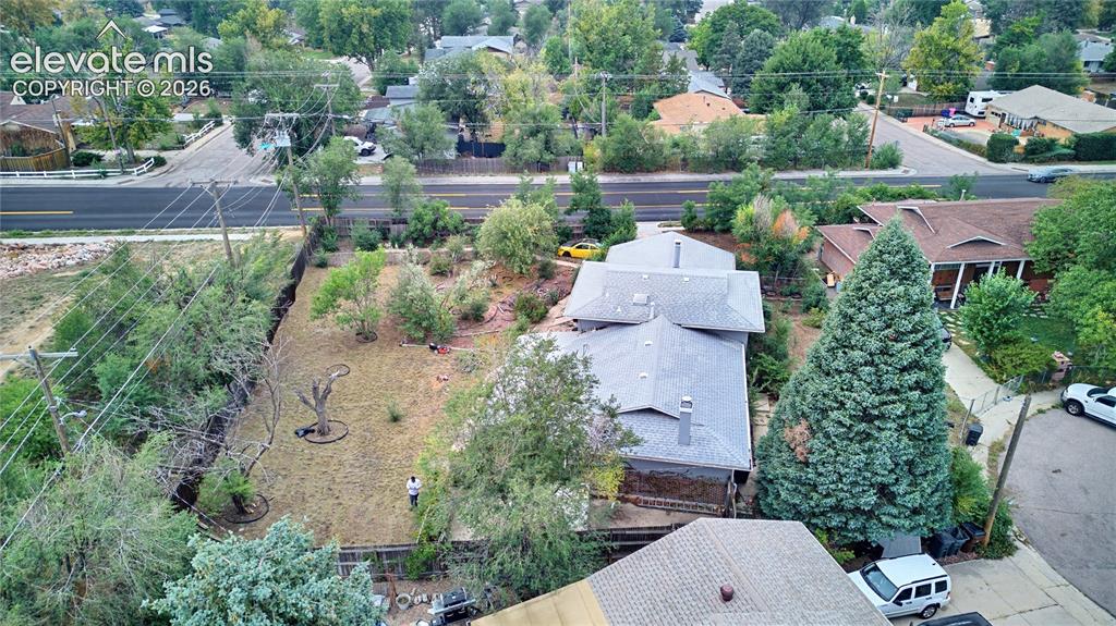 Image 43 of 45: Expansive lot featuring a residential structure with multiple gables, surro