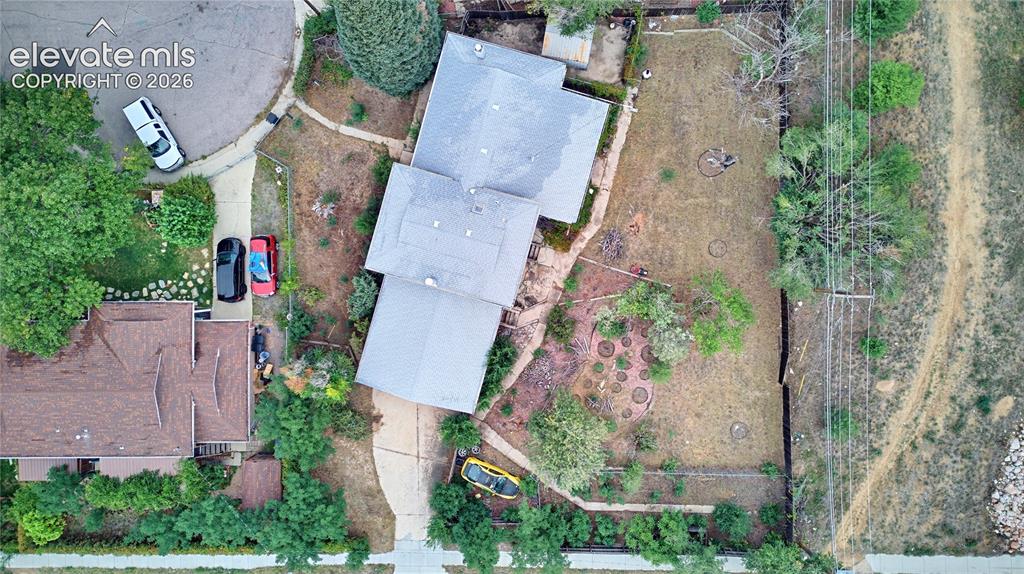 Image 44 of 45: Spacious property with a light-colored shingled roof and a paved driveway