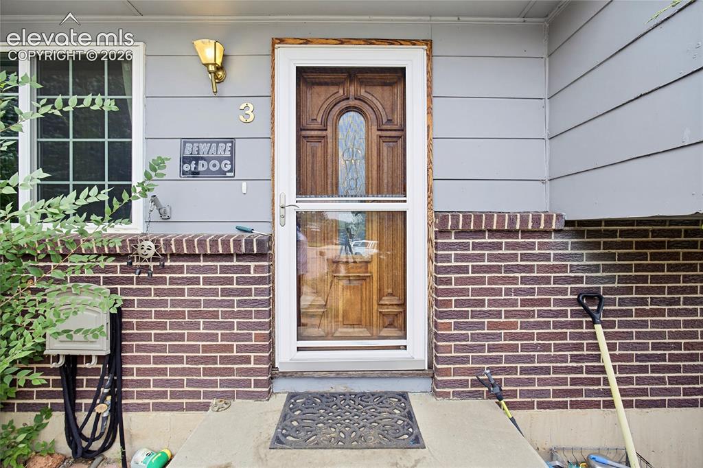 Image 45 of 45: Entryway featuring a wood-finish door with frosted glass detailing, a clear